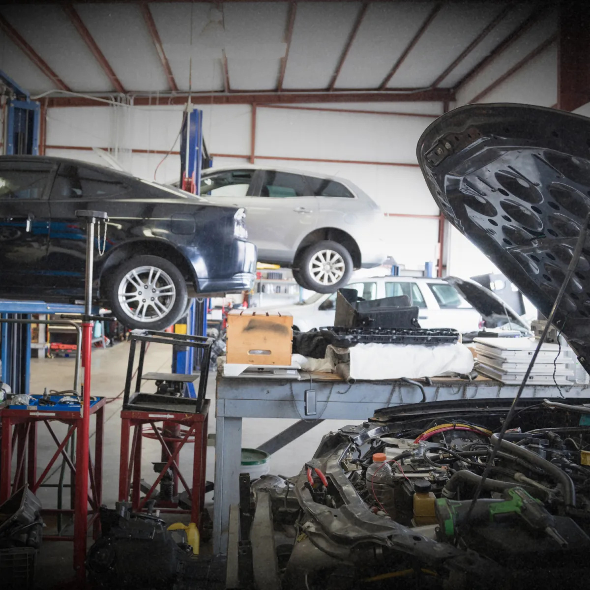 Mechanic inspecting car engine for transmission and drivetrain service