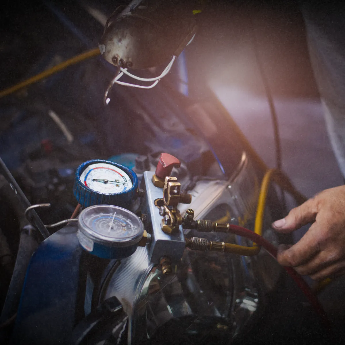 Mechanic inspecting car engine for transmission and drivetrain service