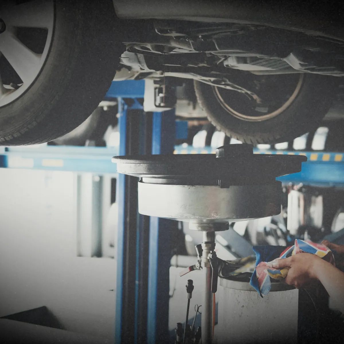Mechanic inspecting car engine for transmission and drivetrain service