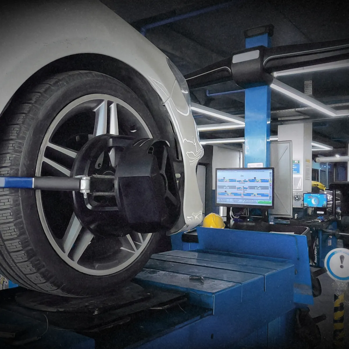 Mechanic inspecting car engine for transmission and drivetrain service