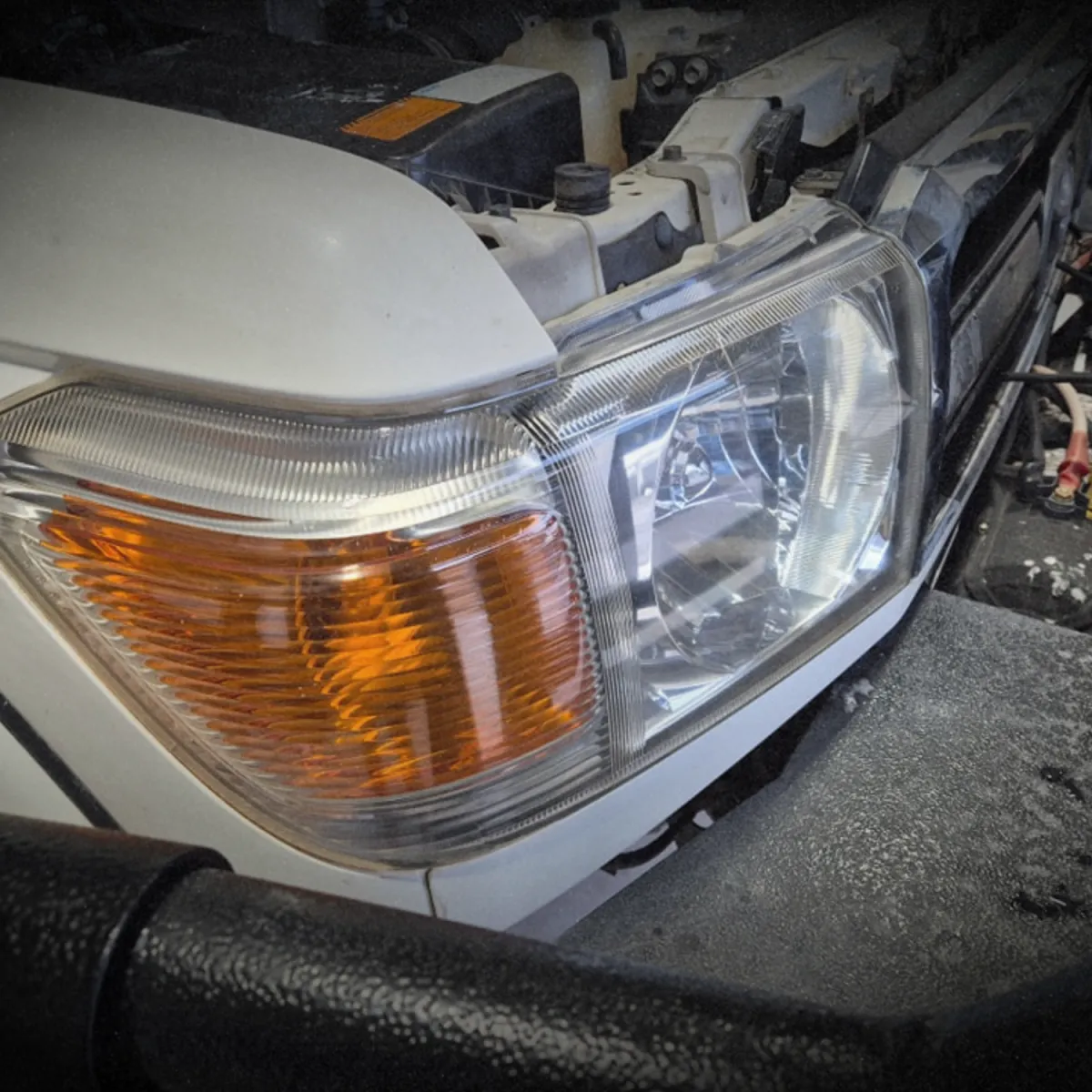 Mechanic inspecting car engine for transmission and drivetrain service