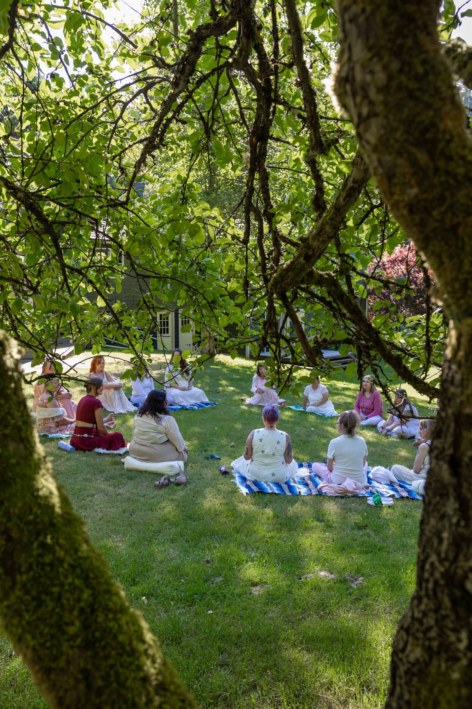 Women practicing guided meditation in the Alaskan wilderness for relaxation and inner healing.