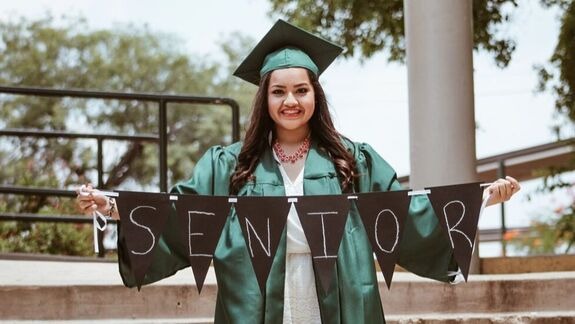 high school senior holding sign