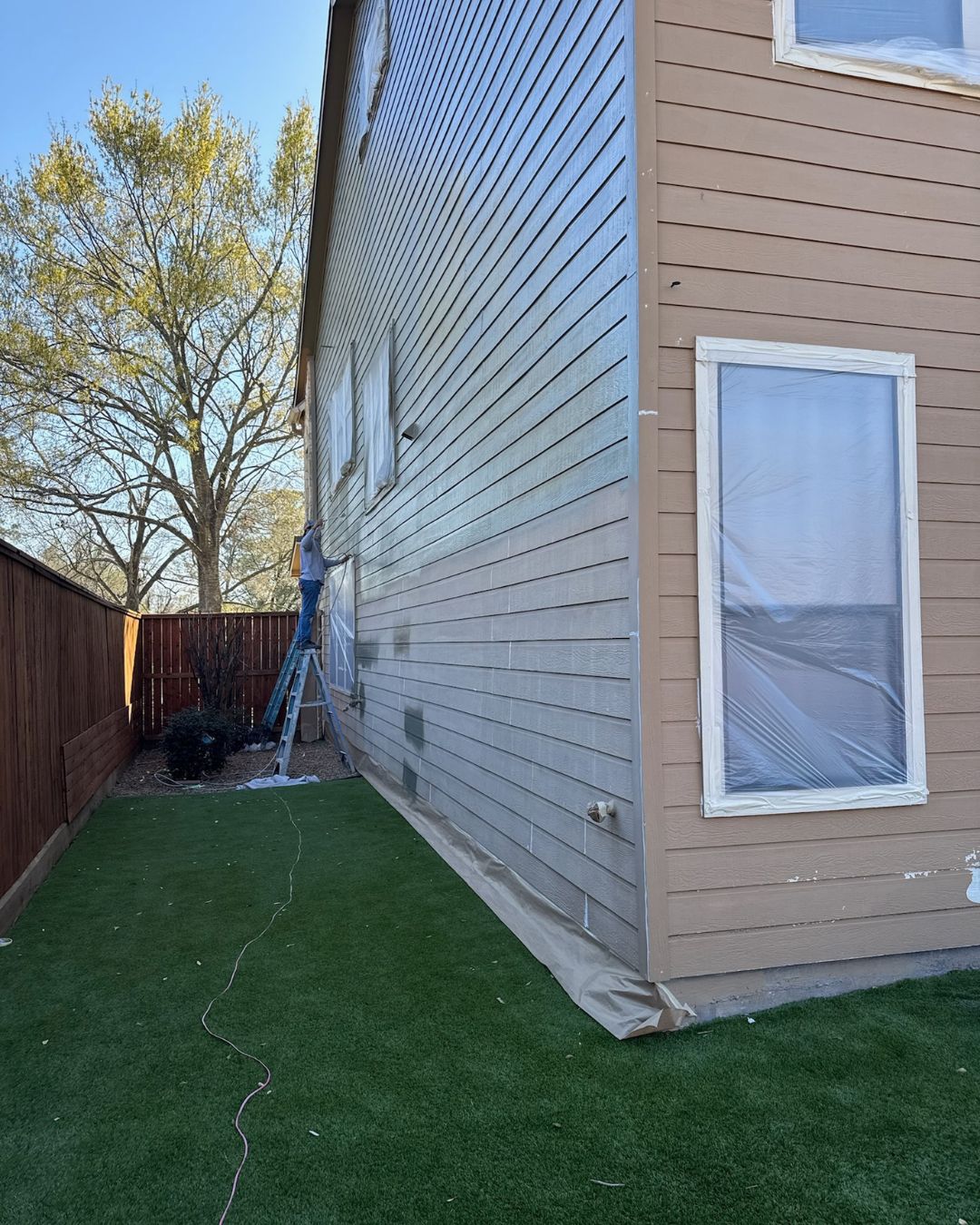 Exterior siding painting on Houston-area home with detailed surface prep