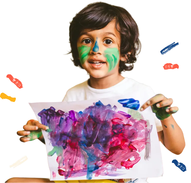 Young child with face paint holding a colorful painting