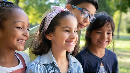 Three students smiling together outdoors