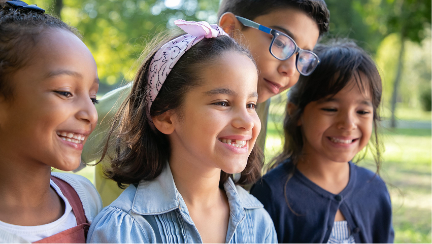 Three students smiling together outdoors
