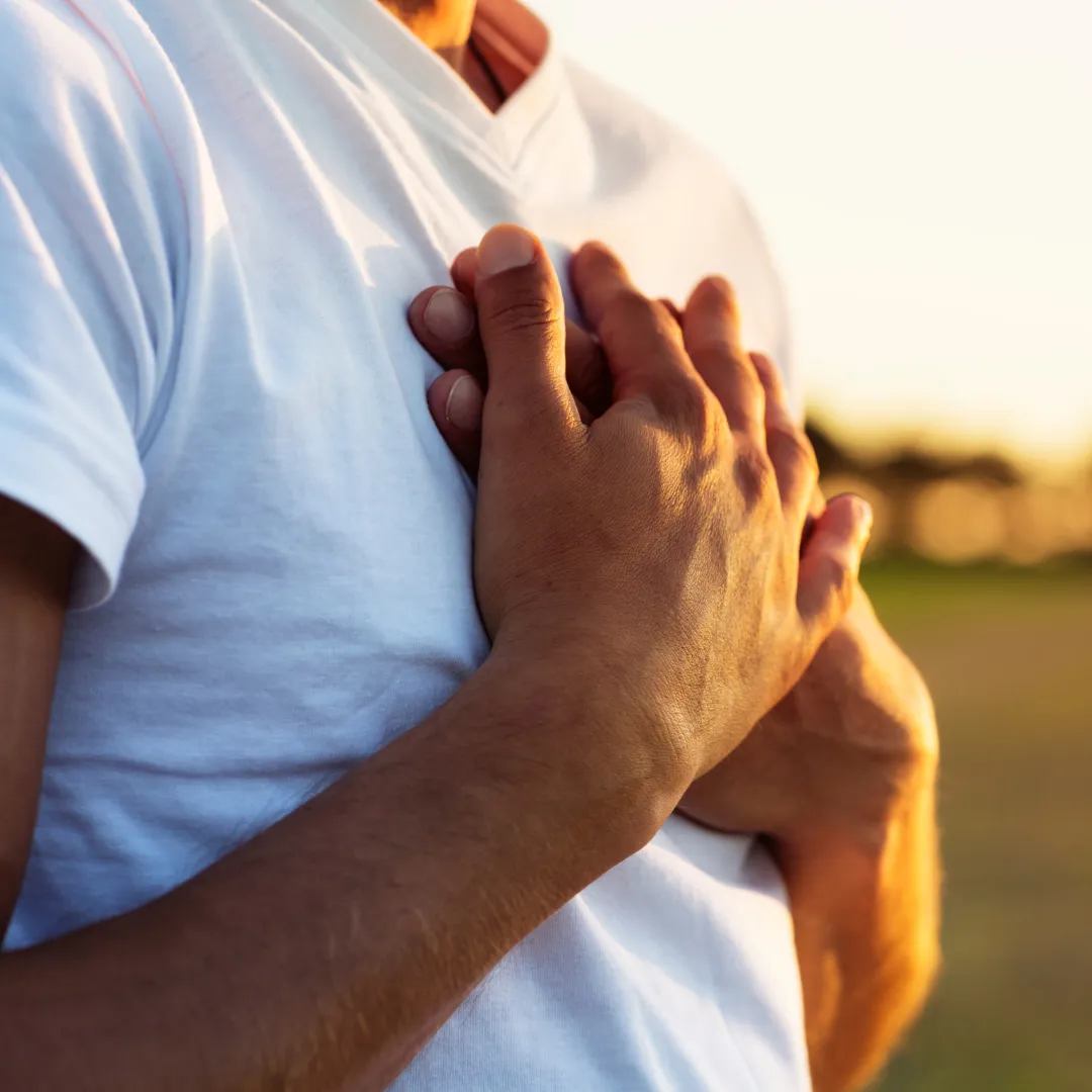 man with hands on his heart