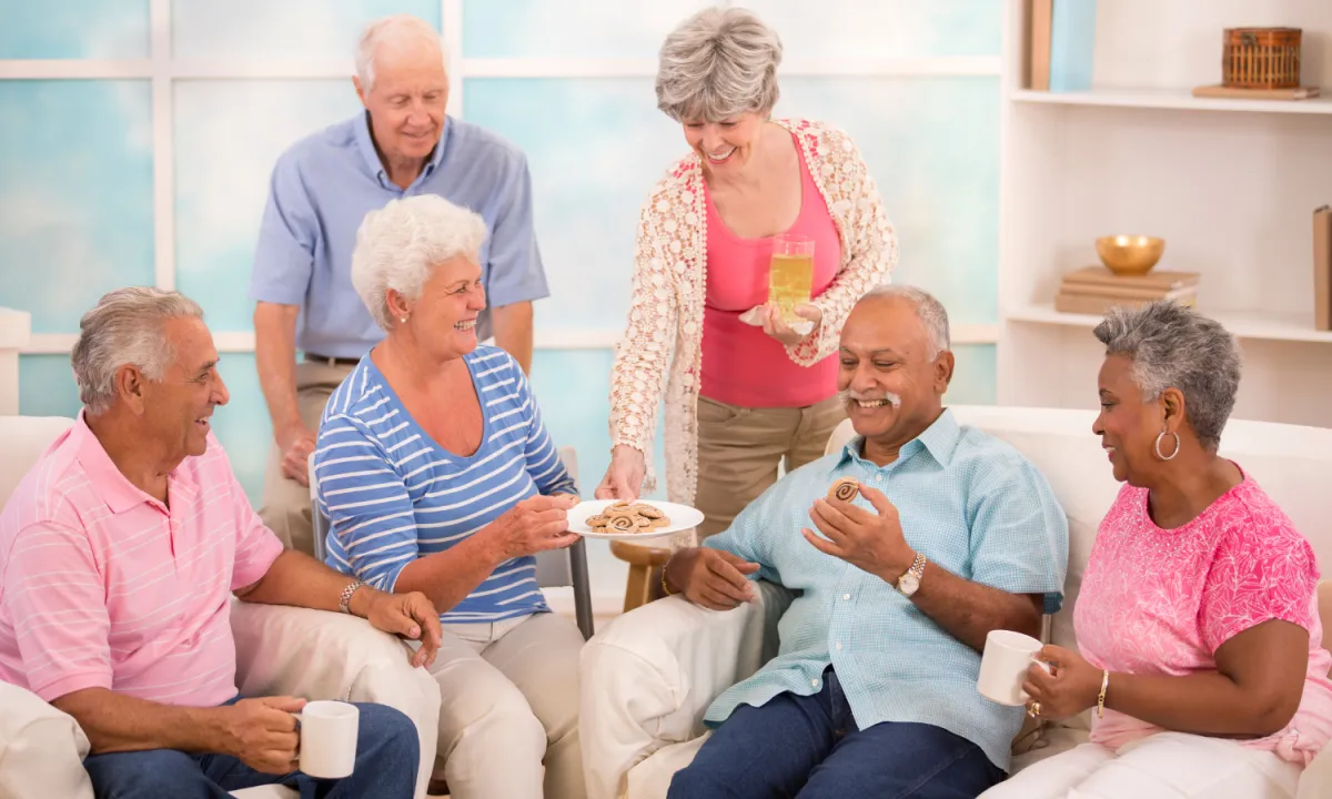Group of seniors enjoying coffee together in a senior living community – promoting connection and quality of life through EverCare Placement.
