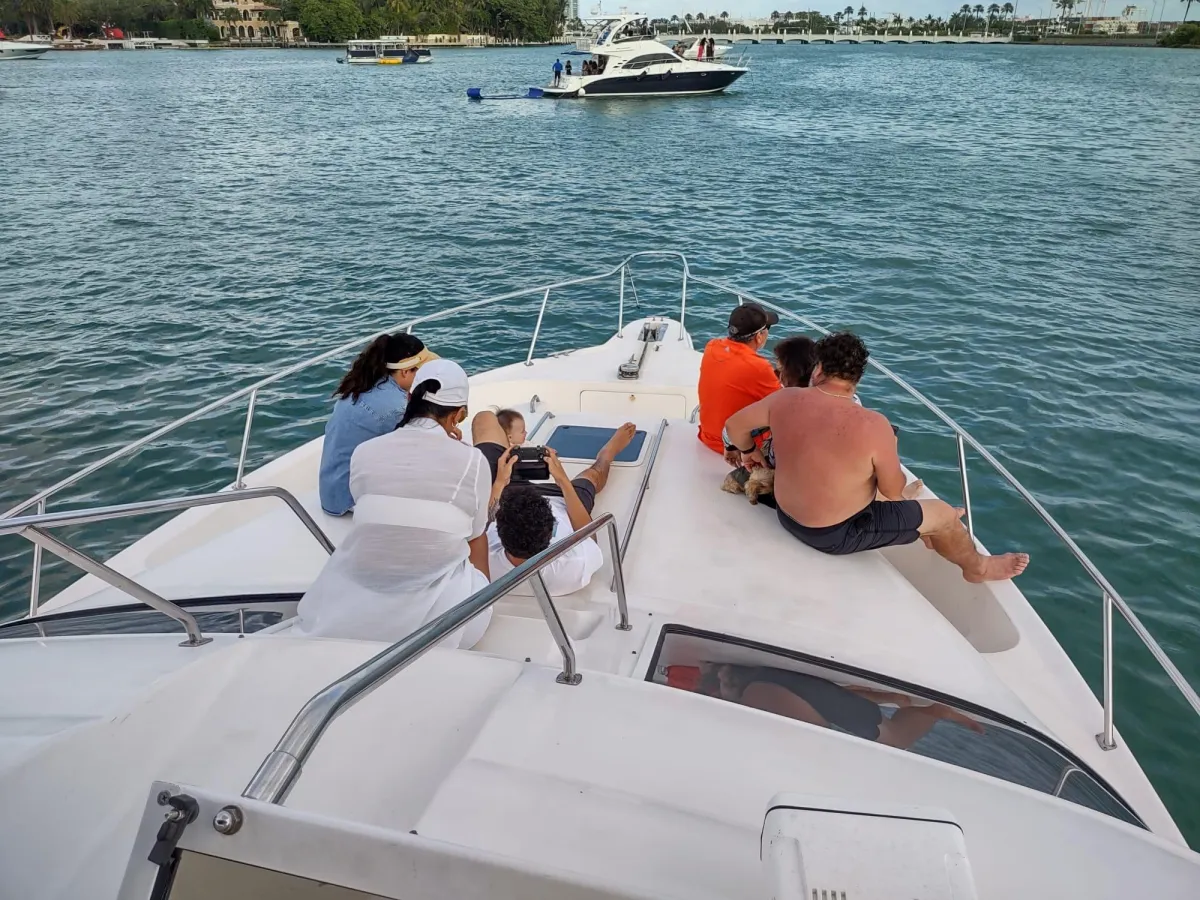 Group of people sitting on the front side of one of the yachts of the Elite Sports Yachts in West Palm Beach, FL