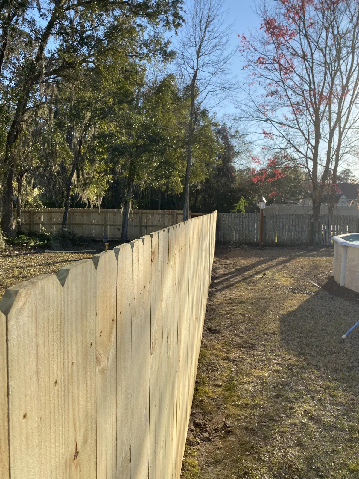 Beautiful wooden custom deck with stairs and railings, expertly installed by Collins Construction & Consulting LLC in Fort Stewart, GA.