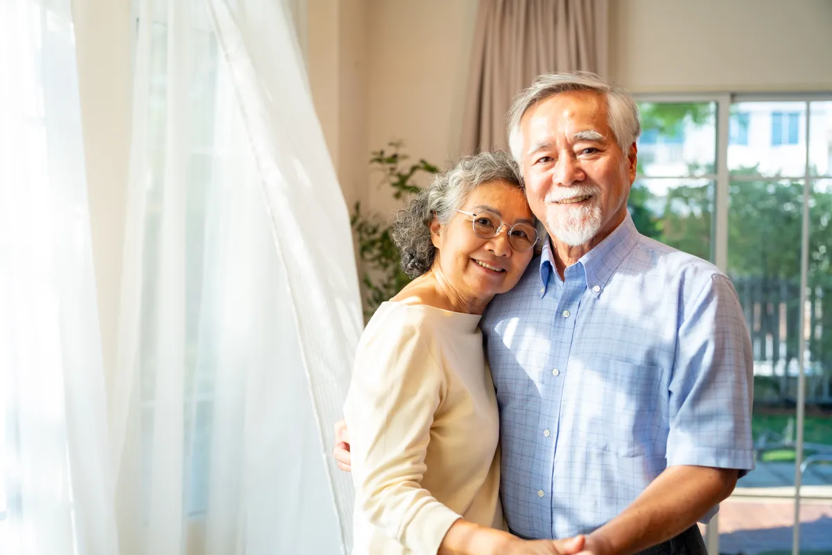 Couple enjoys breeze through open windows of home