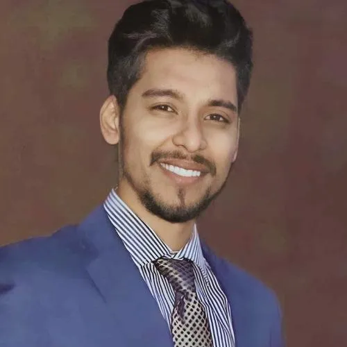 Rezaul Karim in a suit smiling 