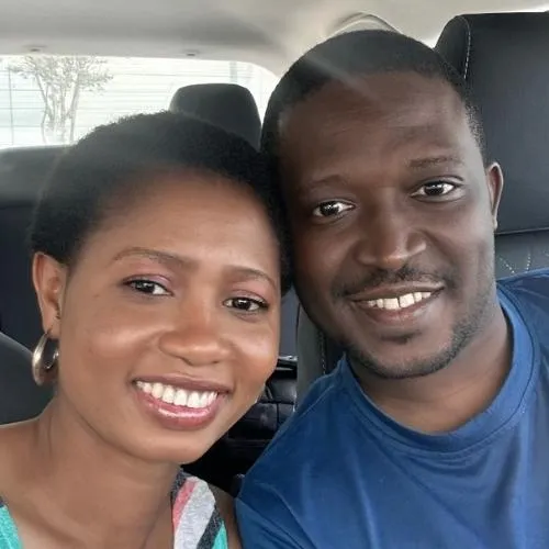 Pastor Amos Gata smiling with his wife next to him
