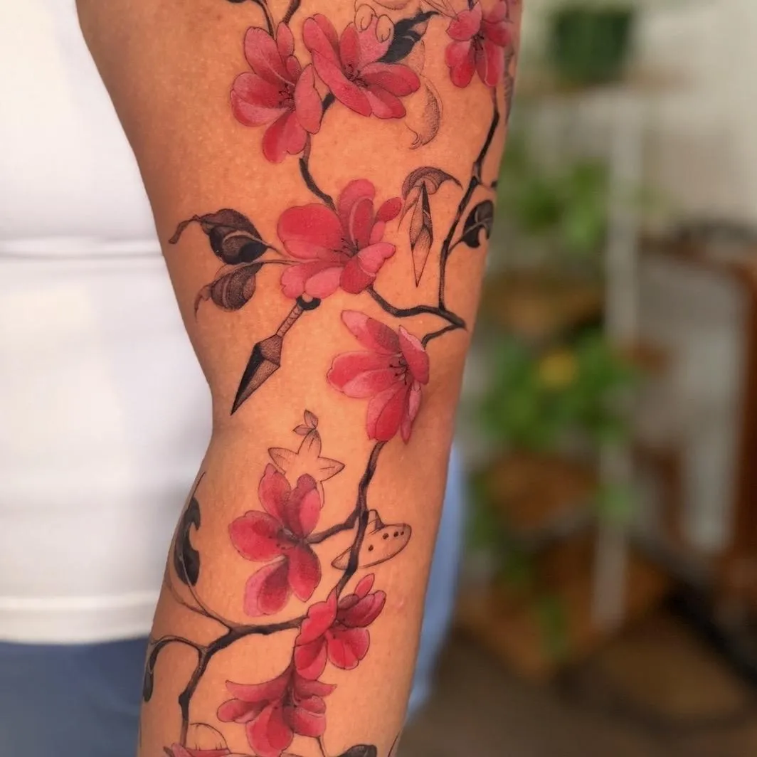 Red and pink cherry blossom tattoo by Golden Koi Tattoos in Hamilton