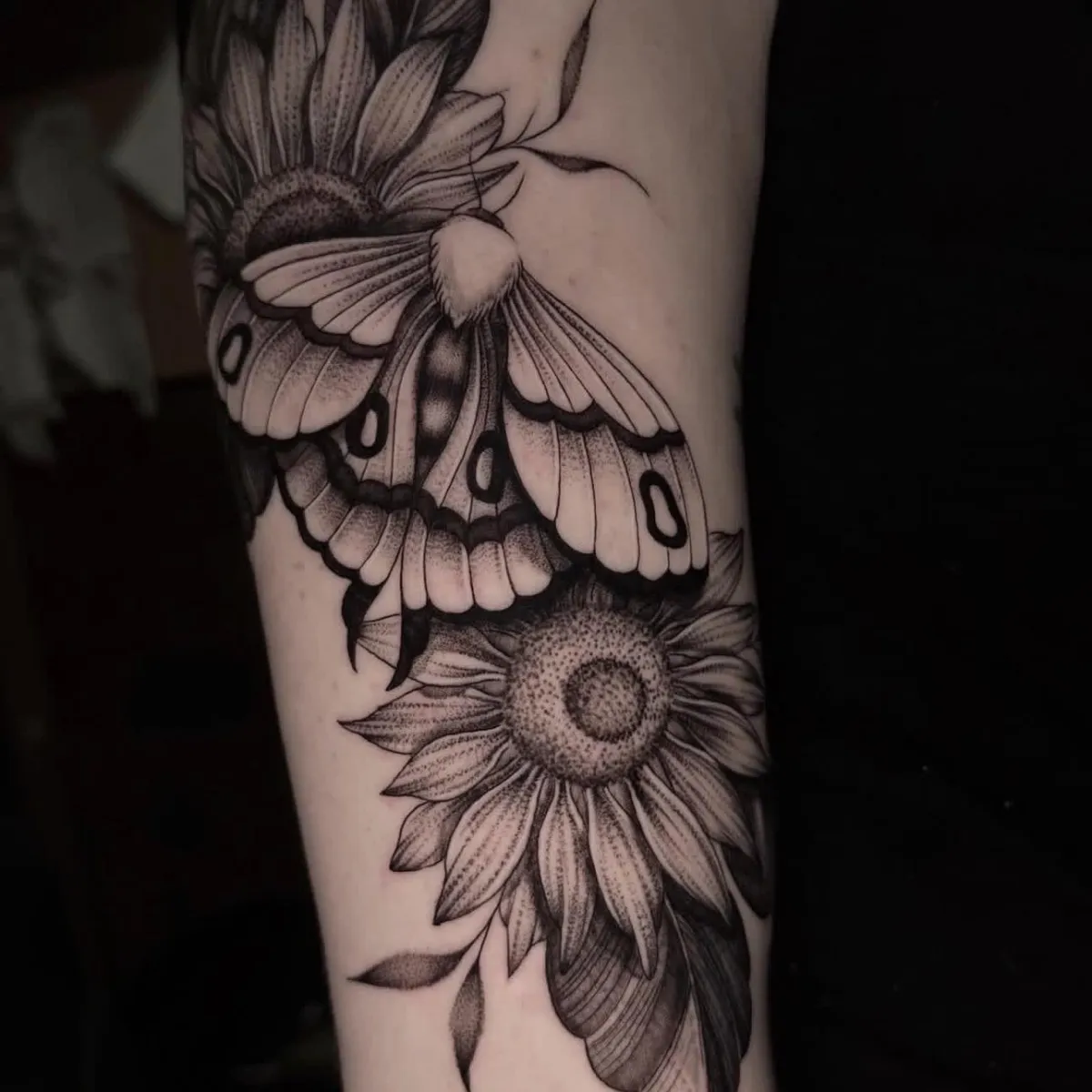 Blackwork moth and floral tattoo by Golden Koi Tattoos