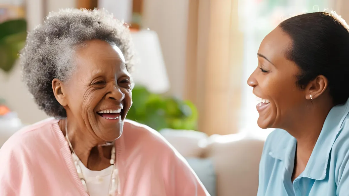 African American woman Personal Care Assistant assisting an elderly person.
