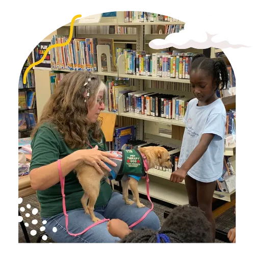 child meeting sensory dog in a library