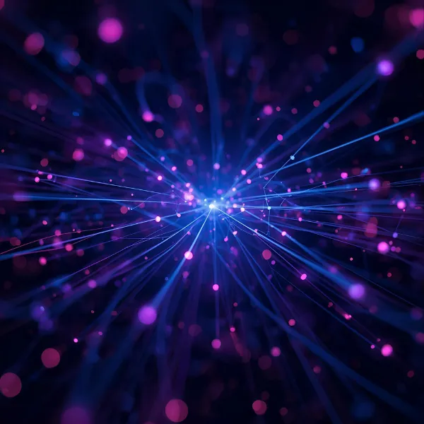A vibrant burst of glowing blue and purple light trails with scattered particles radiating from a central point, creating an abstract futuristic energy or data flow effect.