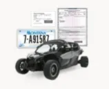 A black off-road vehicle with a license plate and a registration document beside it.