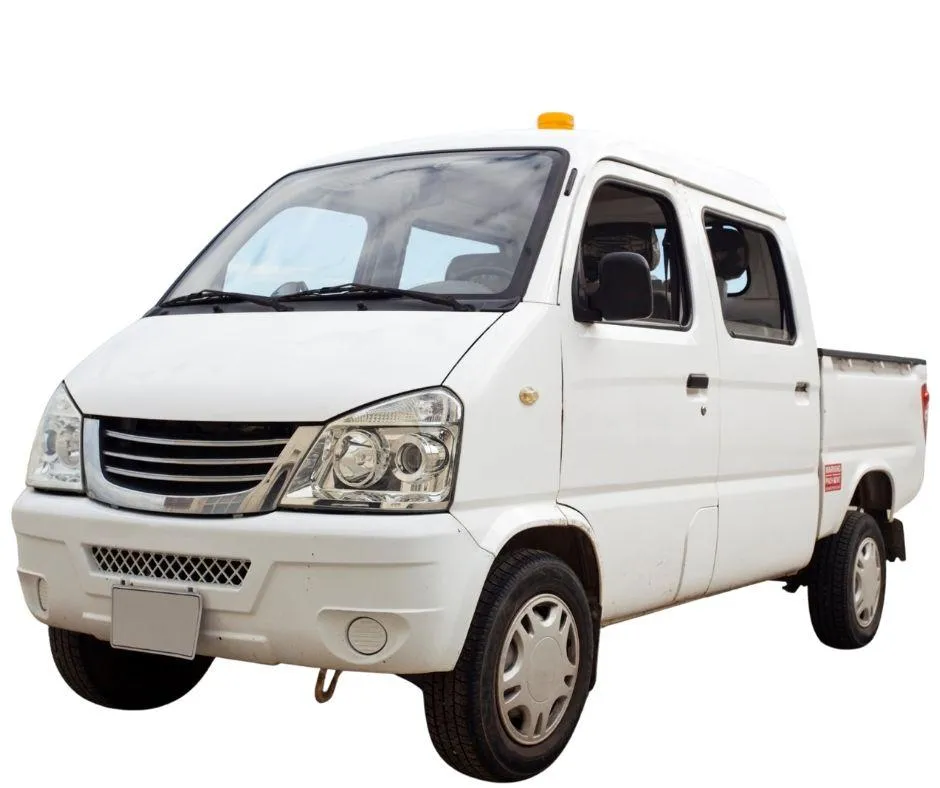 A white cab-over mini truck with a cargo bed and amber roof light.