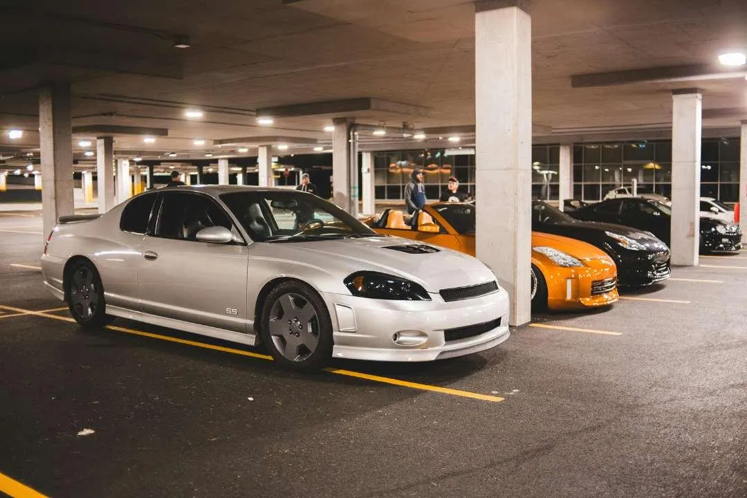 Vehicles in a parking lot representing California Title Transfer Fees and Taxes, covering costs for car ownership transfer.