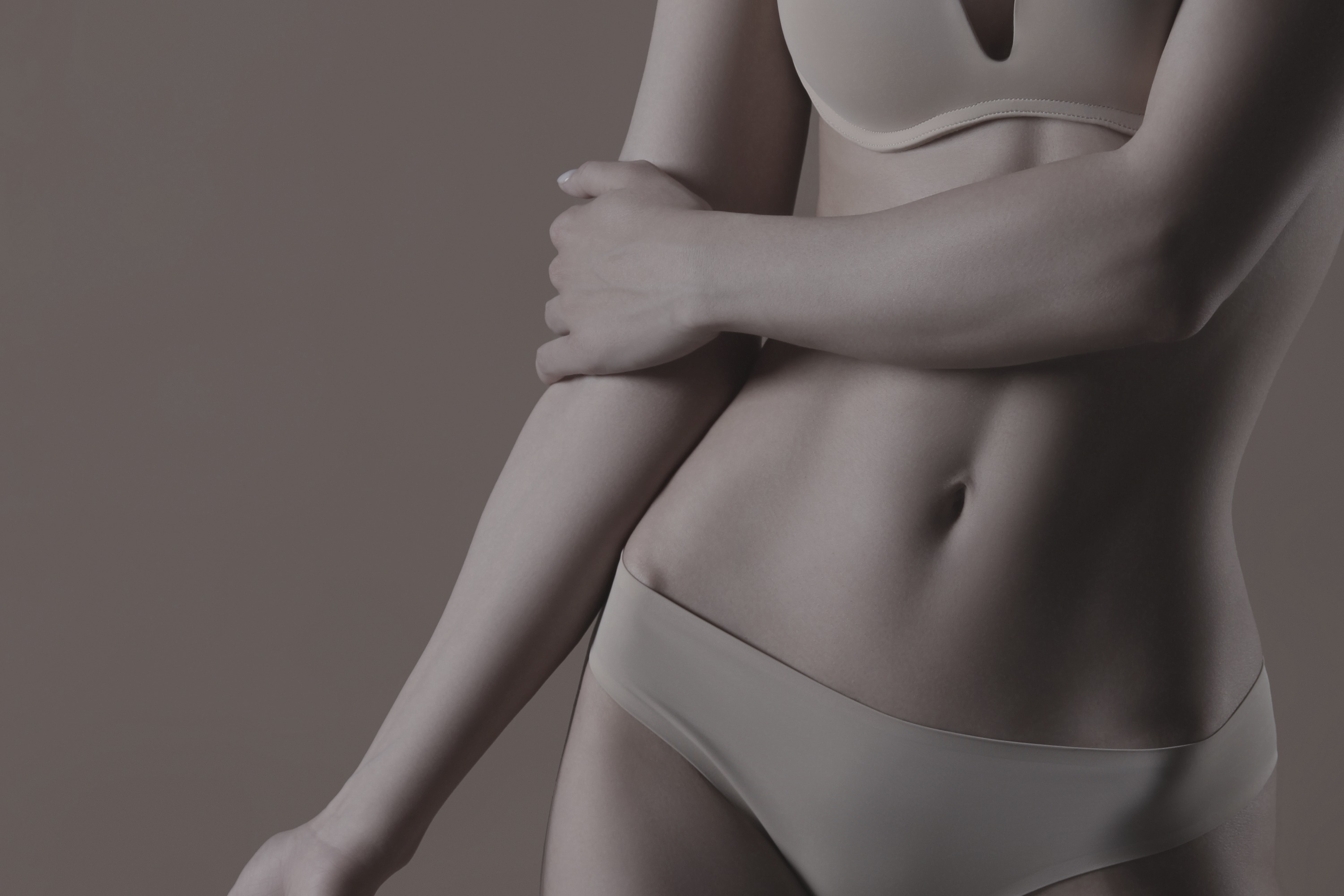 person holding clear glass bottle