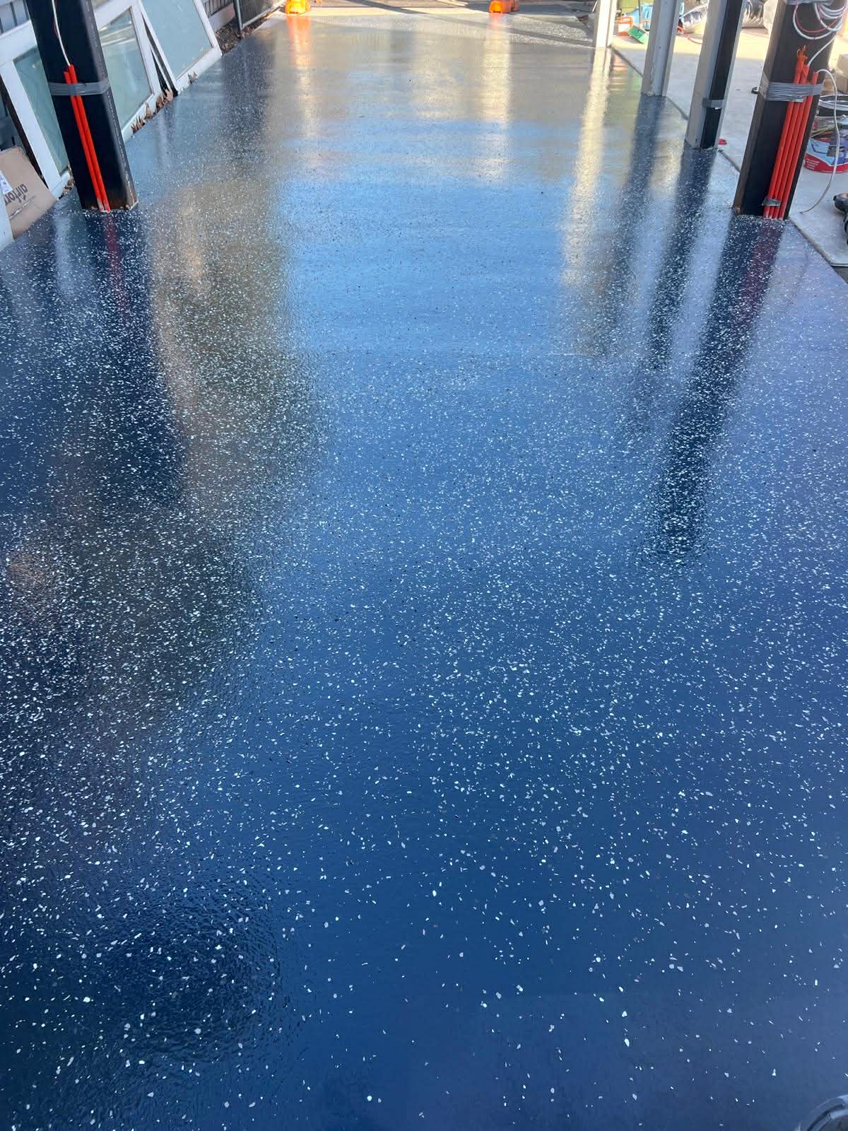 black epoxy floor with white flakes