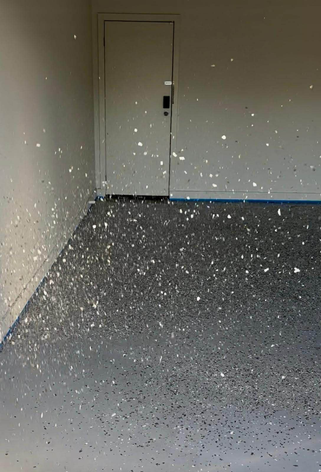 flakes being distributed on epoxy floor