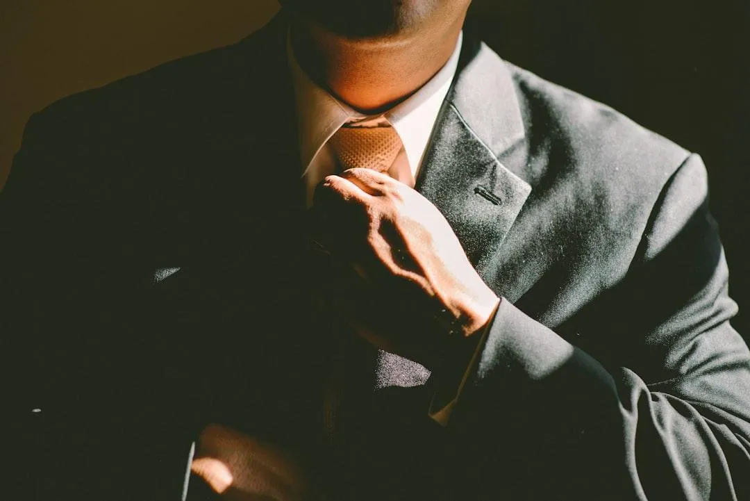 A man tightening his tie.