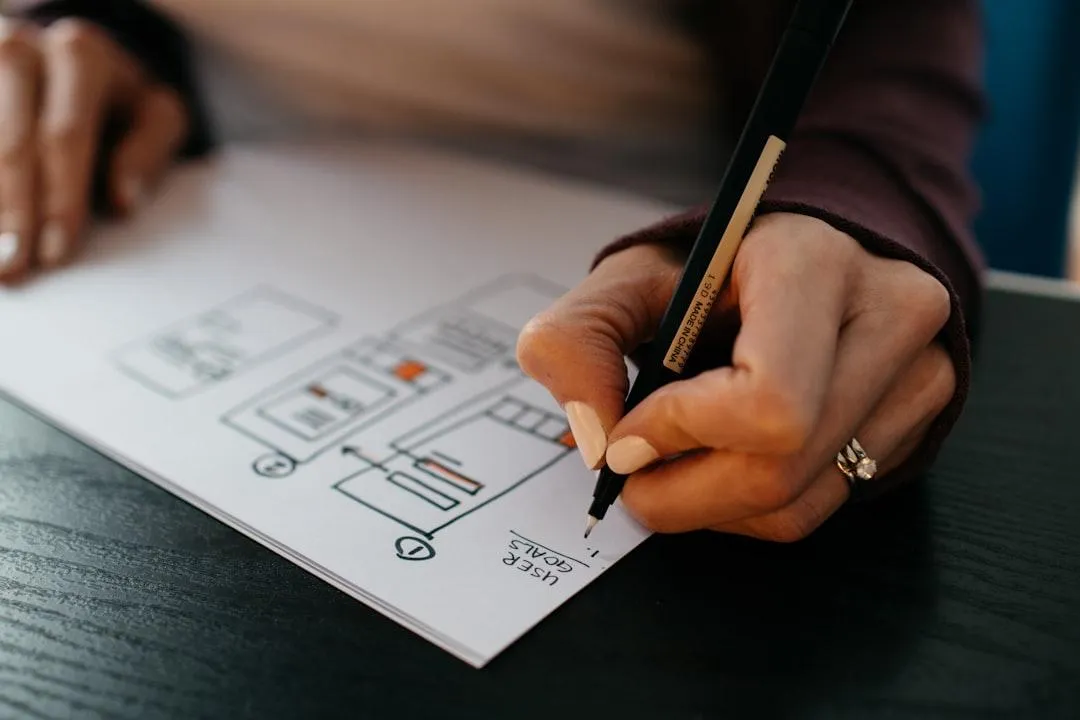 A person diagramming with pen on paper.
