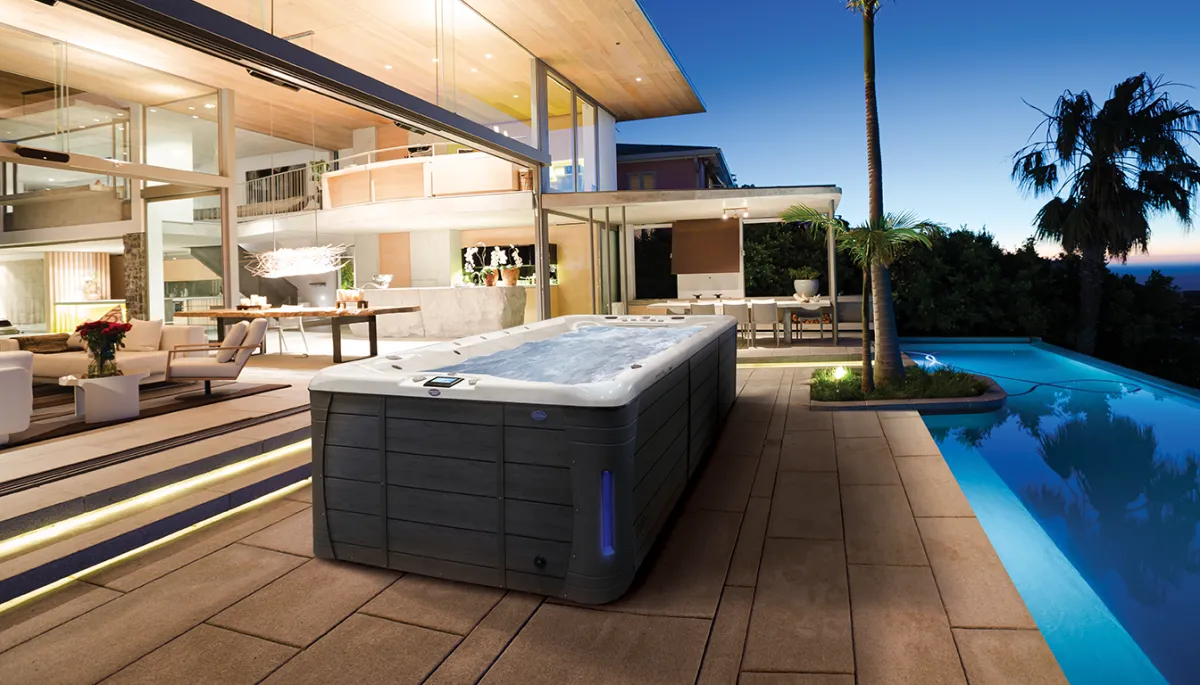 Swim spa in a landscaped backyard