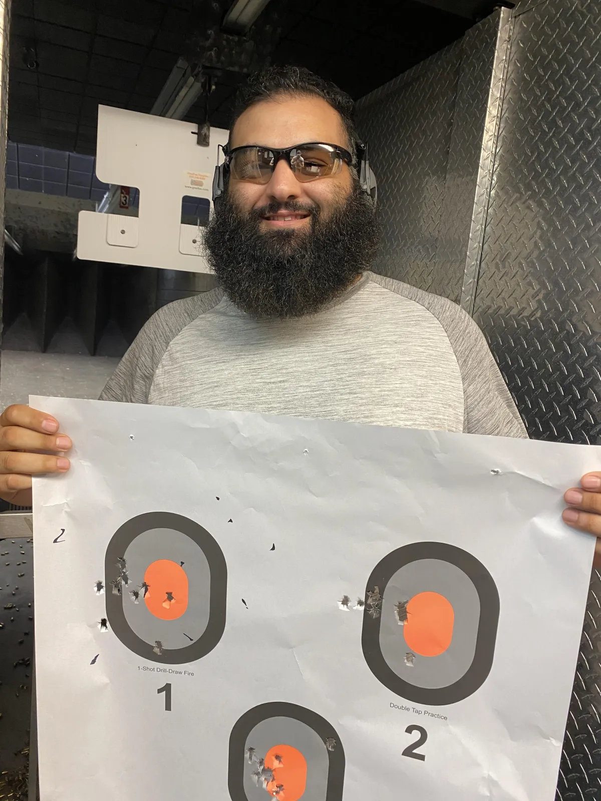 private gun range class student holding target