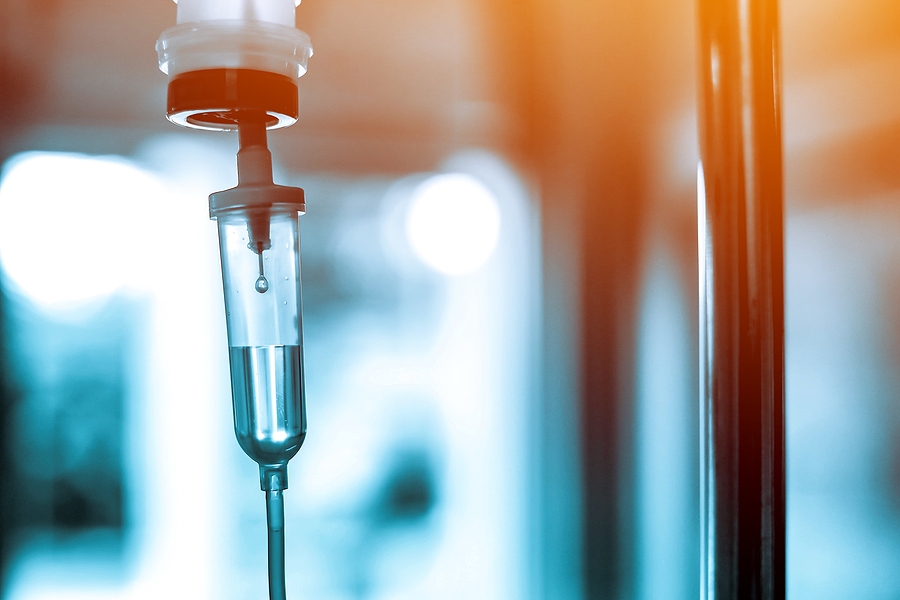 Large institutional buildings surrounded by green lawns and trees.