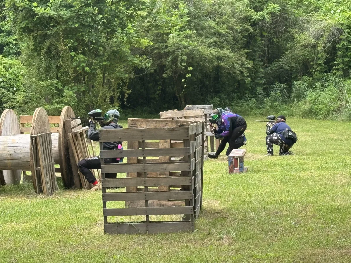 Player taking cover on Bear Ridge Paintball’s outdoor pallet field in Jasper, Georgia.
