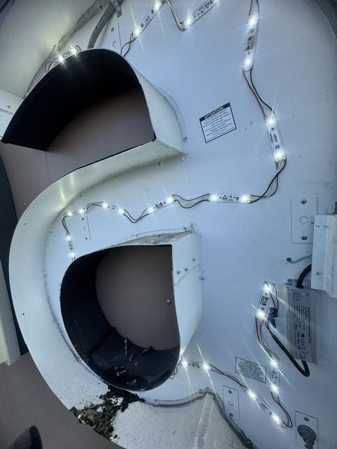 Open channel letter with LED modules and wiring during repair