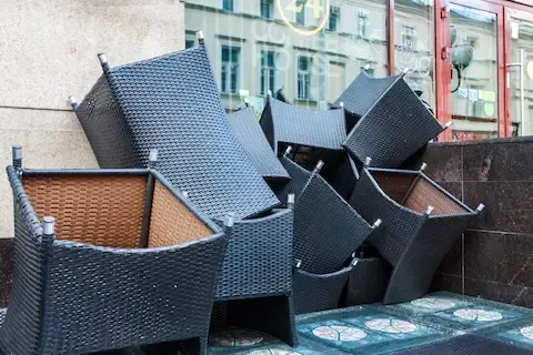 Furniture removal with stacked wicker chairs ready for pickup by West Linn Junk Removal.