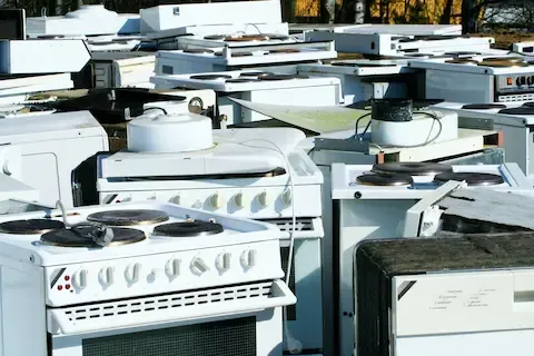 Appliance removal with old stoves and washers ready for hauling by West Linn Junk Removal.