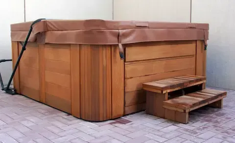 Hot tub removal showing a large wooden spa unit ready for hauling by West Linn Junk Removal.