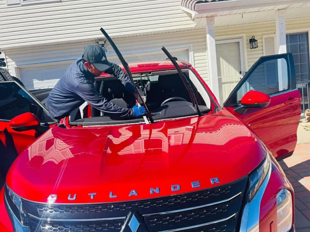 man installing windshield
