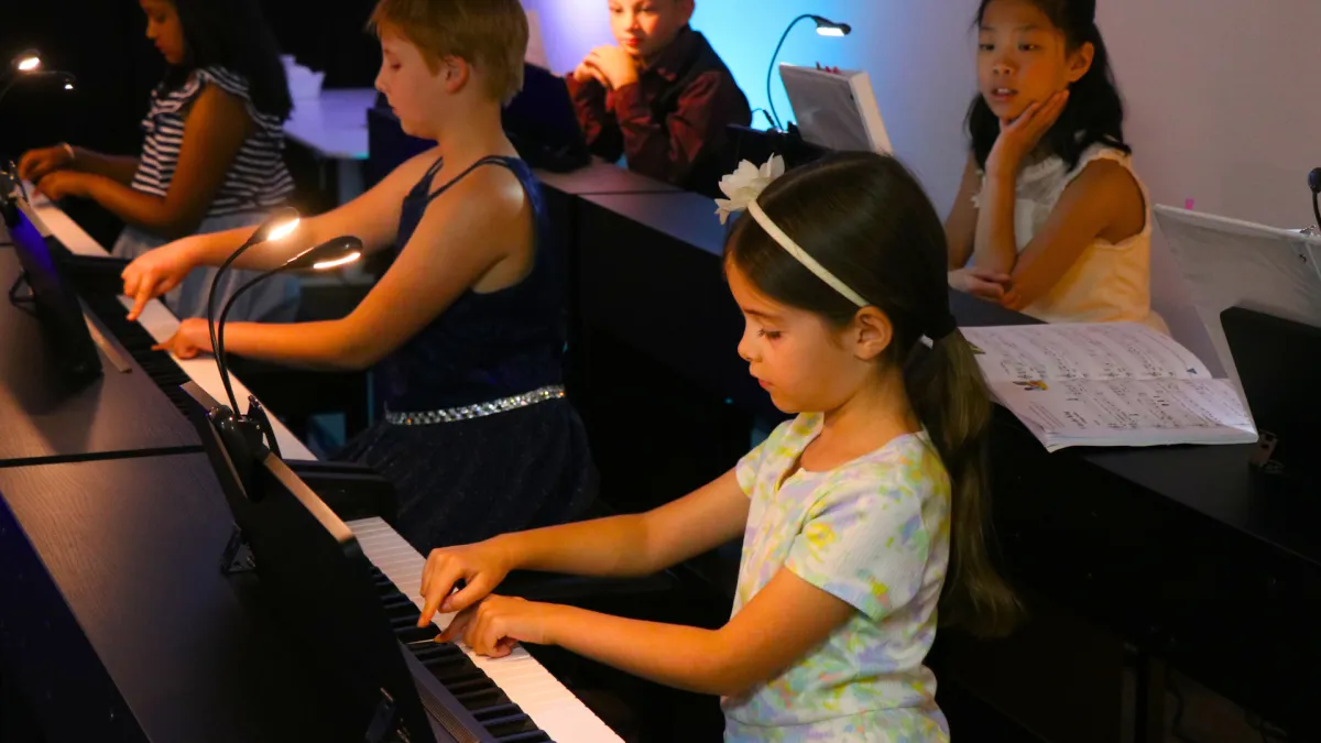 A silver trumpet lies on a dark surface.