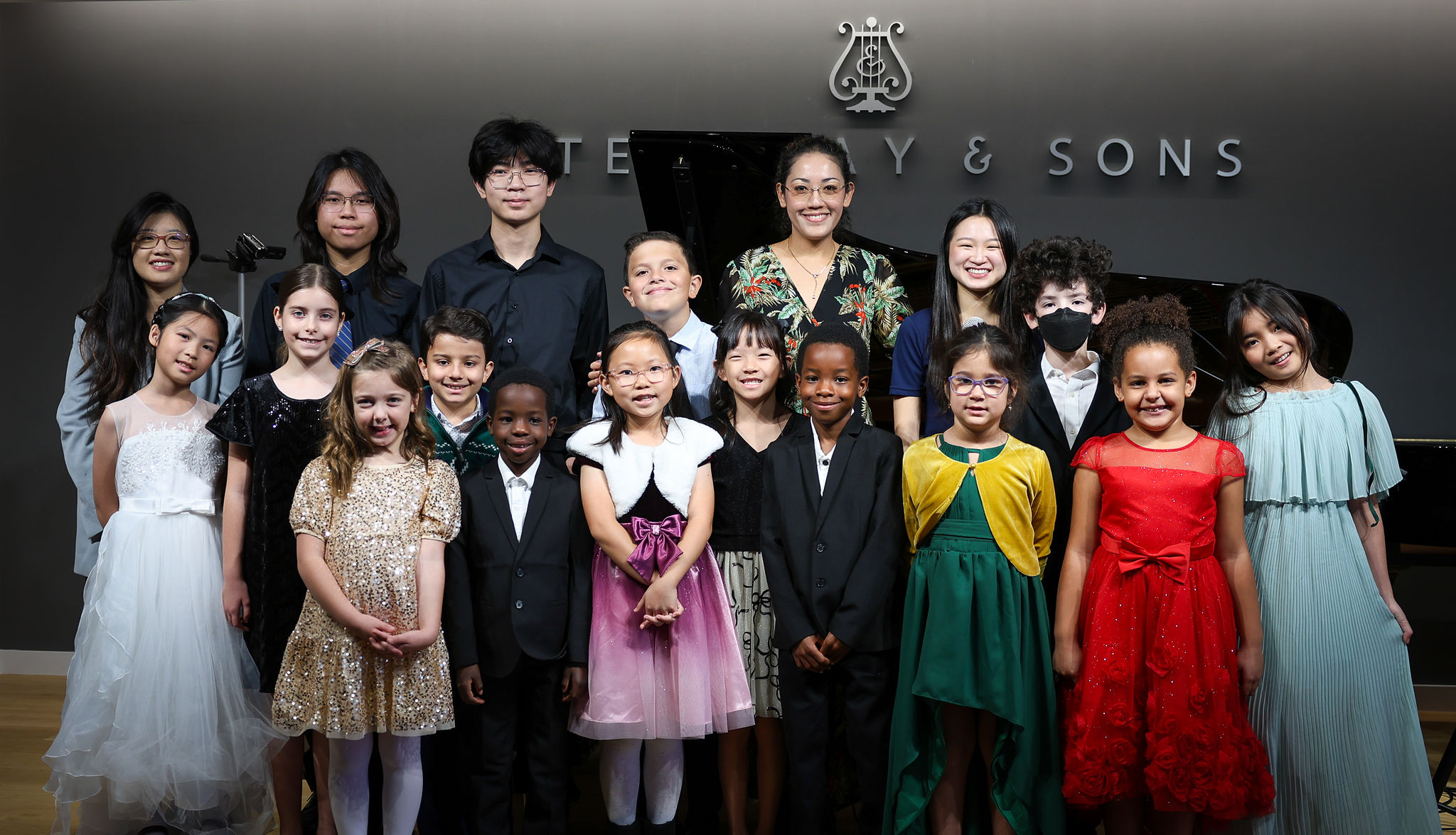 Hands playing a grand piano in black and white