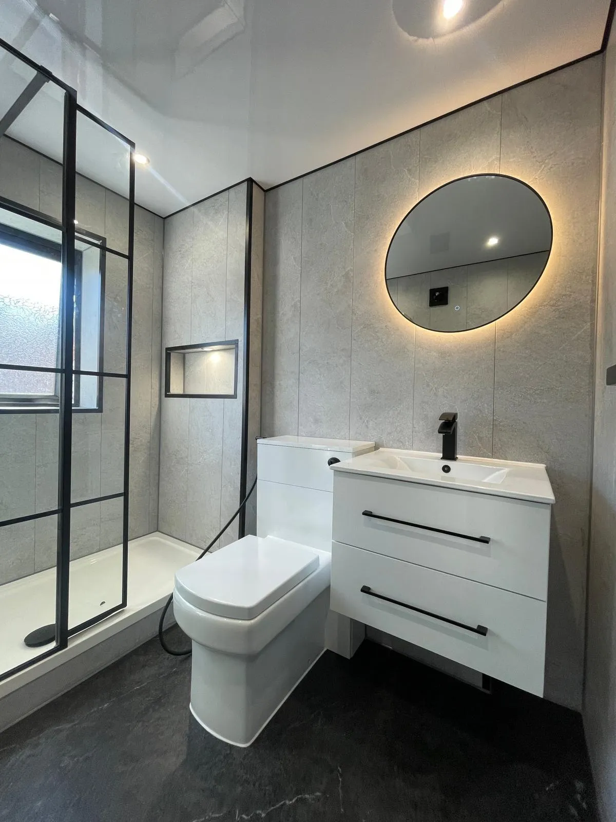 a bath room with a chair a window and a radiator