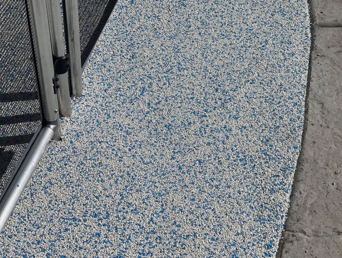 Modern grid-style paver patio with synthetic turf joints and contrasting hardscape textures – custom installation for enhanced drainage and visual impact.