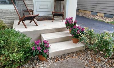 Front house steps redone by CR Concrete Construction showcasing skilled concrete installation.