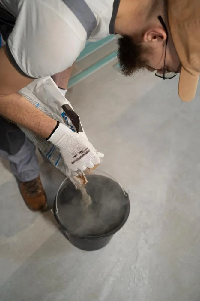 CR Concrete Construction worker mixing concrete for installation and concrete replacement