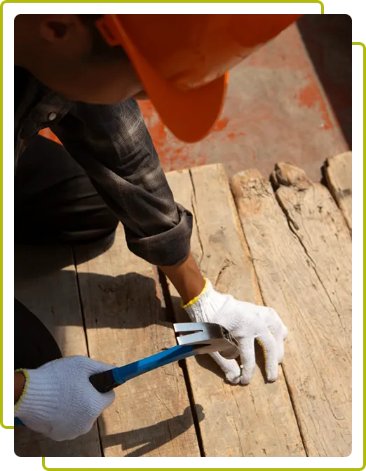 Man using hammer to nail in wooden slab used for concrete stabilization walls