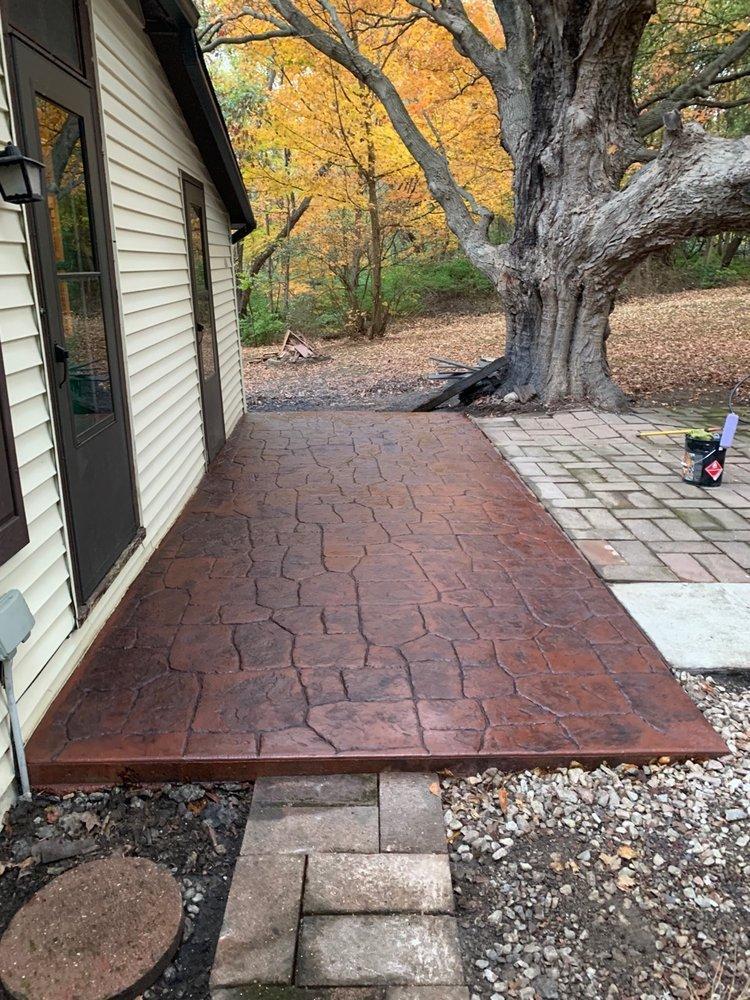 Decorative concrete showcased with custom reddish concrete coloring to add a unique style for any property