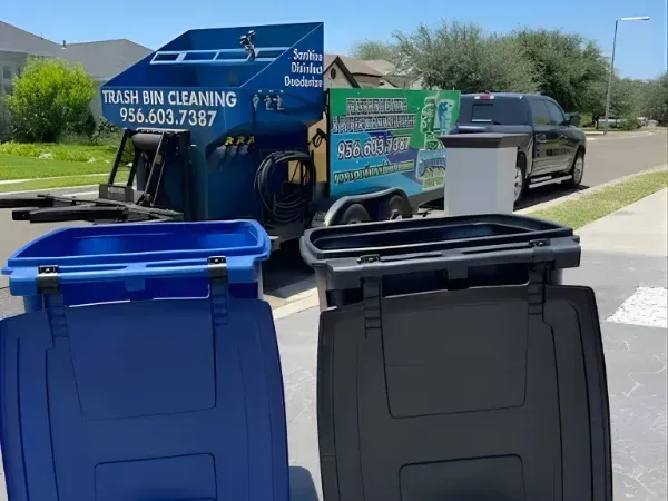 Trash bin cleaning truck servicing curbside bins in a residential area