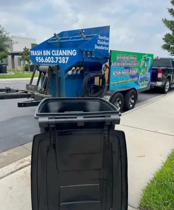 Trash bin cleaning truck lifting residential garbage can for pressure washing